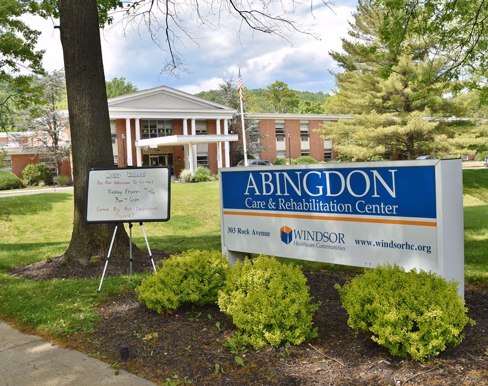 Exterior view of Abingdon Care and Rehabilitation Center with front sign and landscaped grounds.