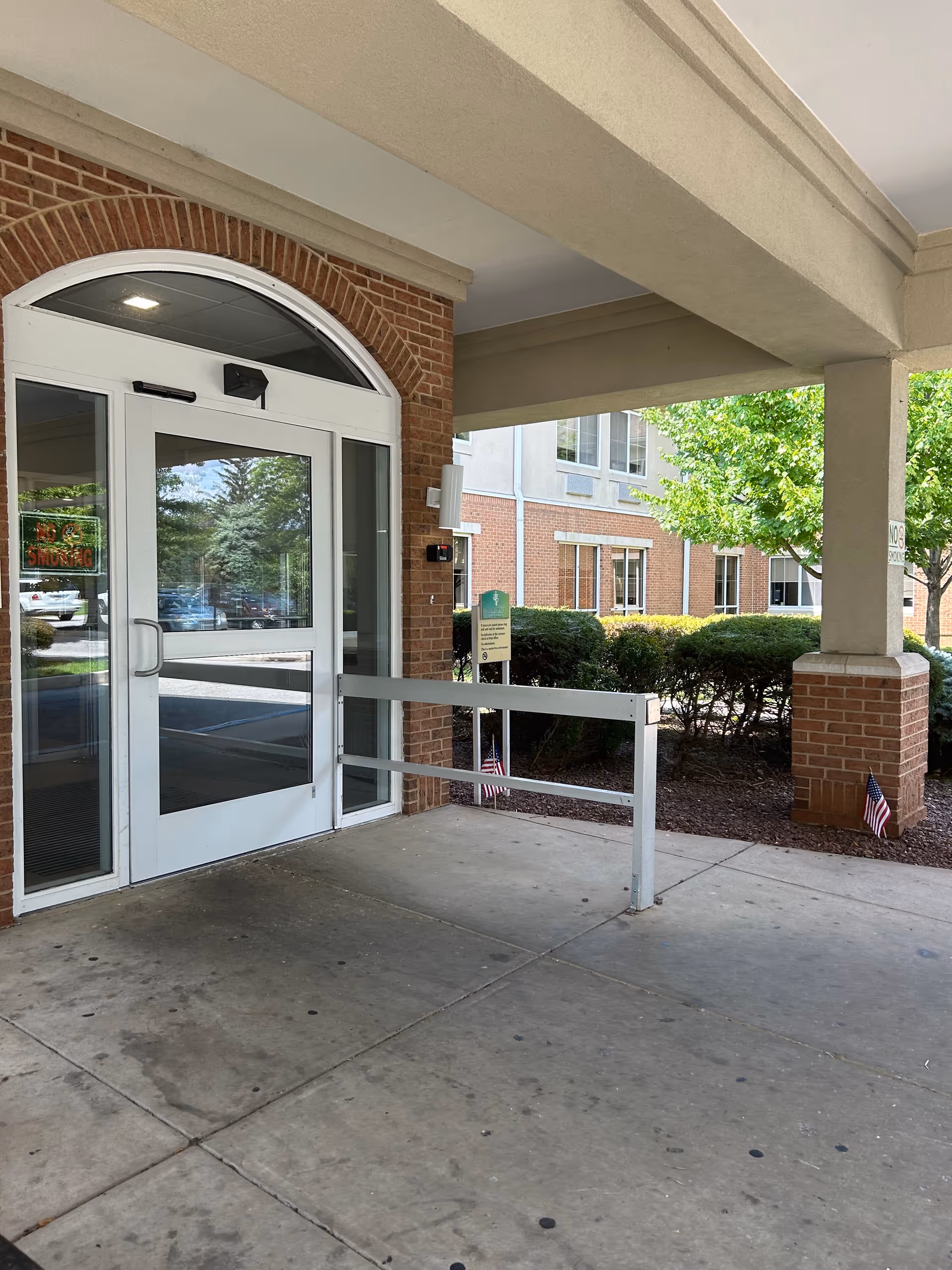 Exterior view of Providence at Mercy Fitzgerald entrance with brick facade and glass doors.
