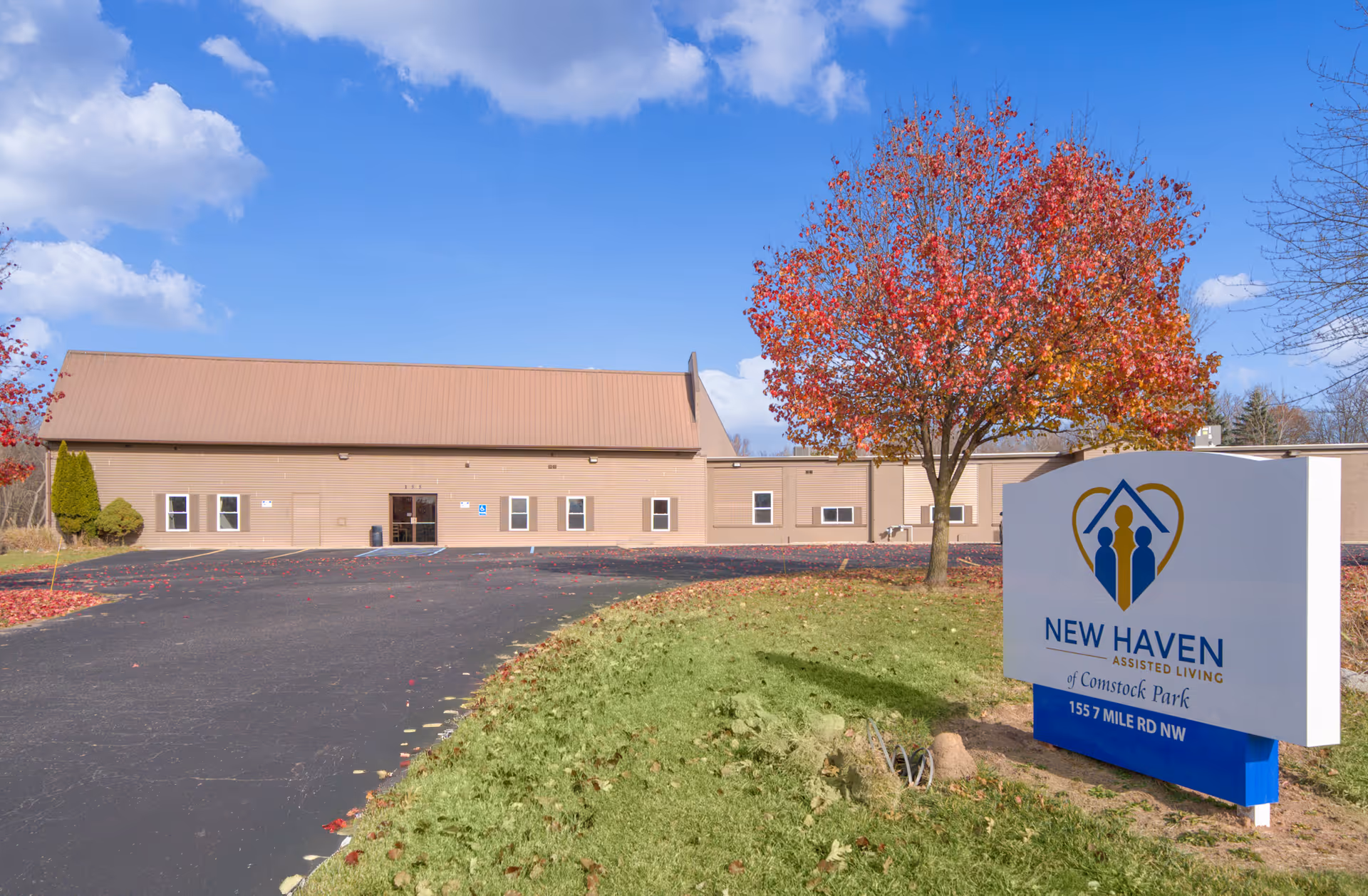 Exterior view of New Haven Assisted Living building with parking lot and sign.