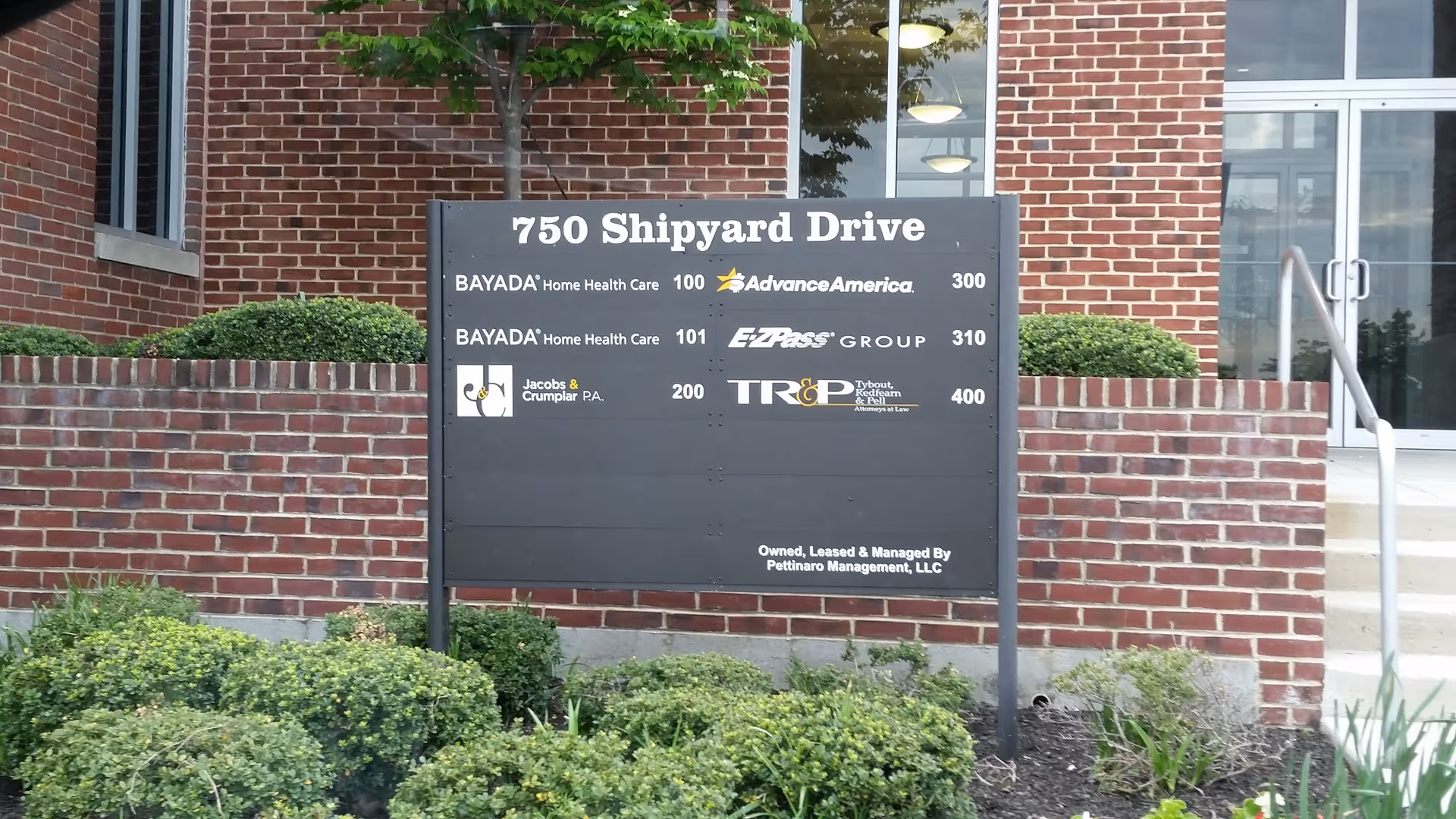 Exterior view of a brick Bayada building with a large sign displaying 750 Shipyard Drive.