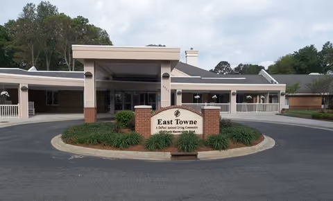 East Towne senior living facility exterior with circular driveway and entrance sign.