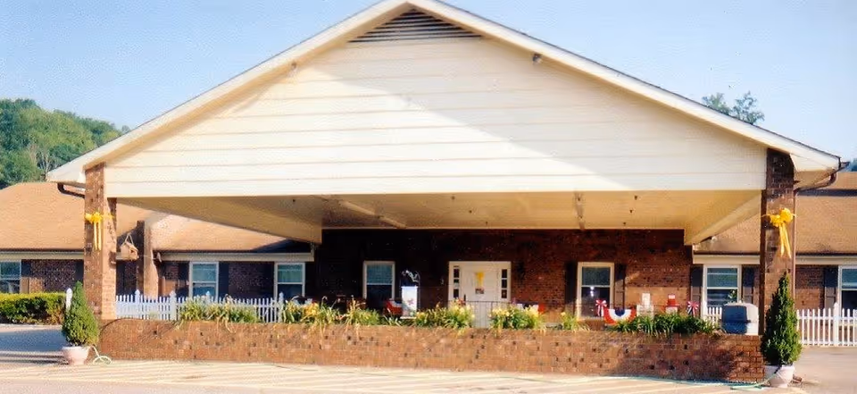 Front view of a single-story brick senior living facility with a wide entrance