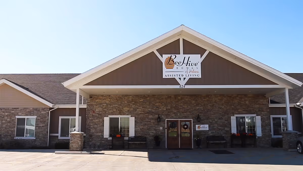 Front view of BeeHive Homes of Helena with stone facade and entrance sign.