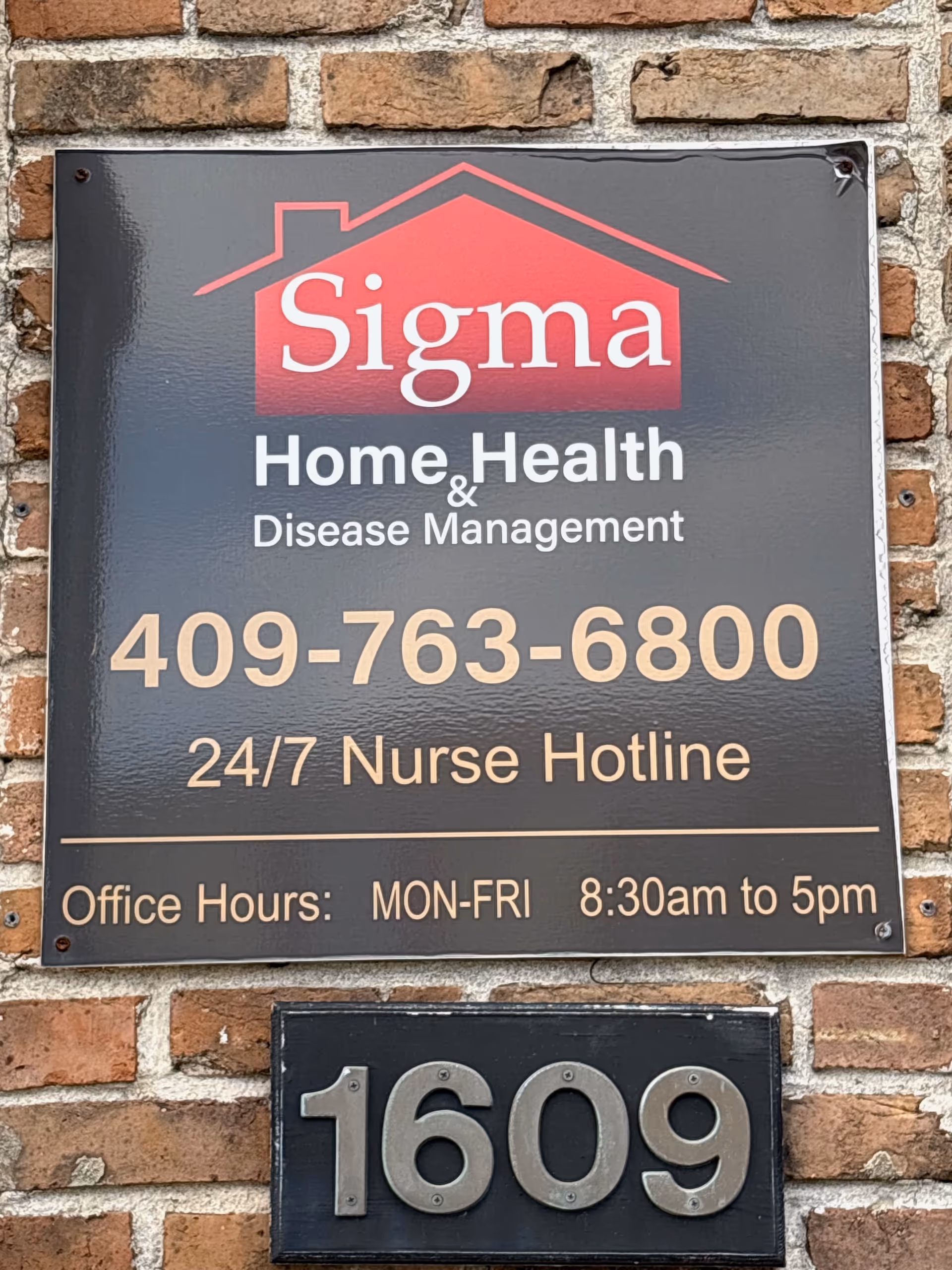 Brick wall with Sigma Home Health sign and 1609 address plaque.