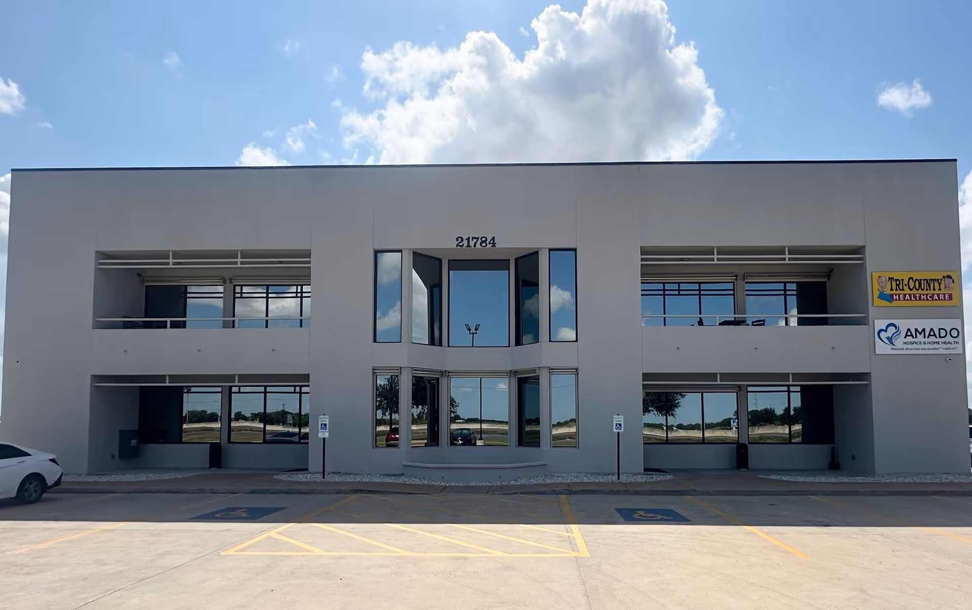 Two-story modern medical facility exterior with large windows and Tri-County Healthcare signage.