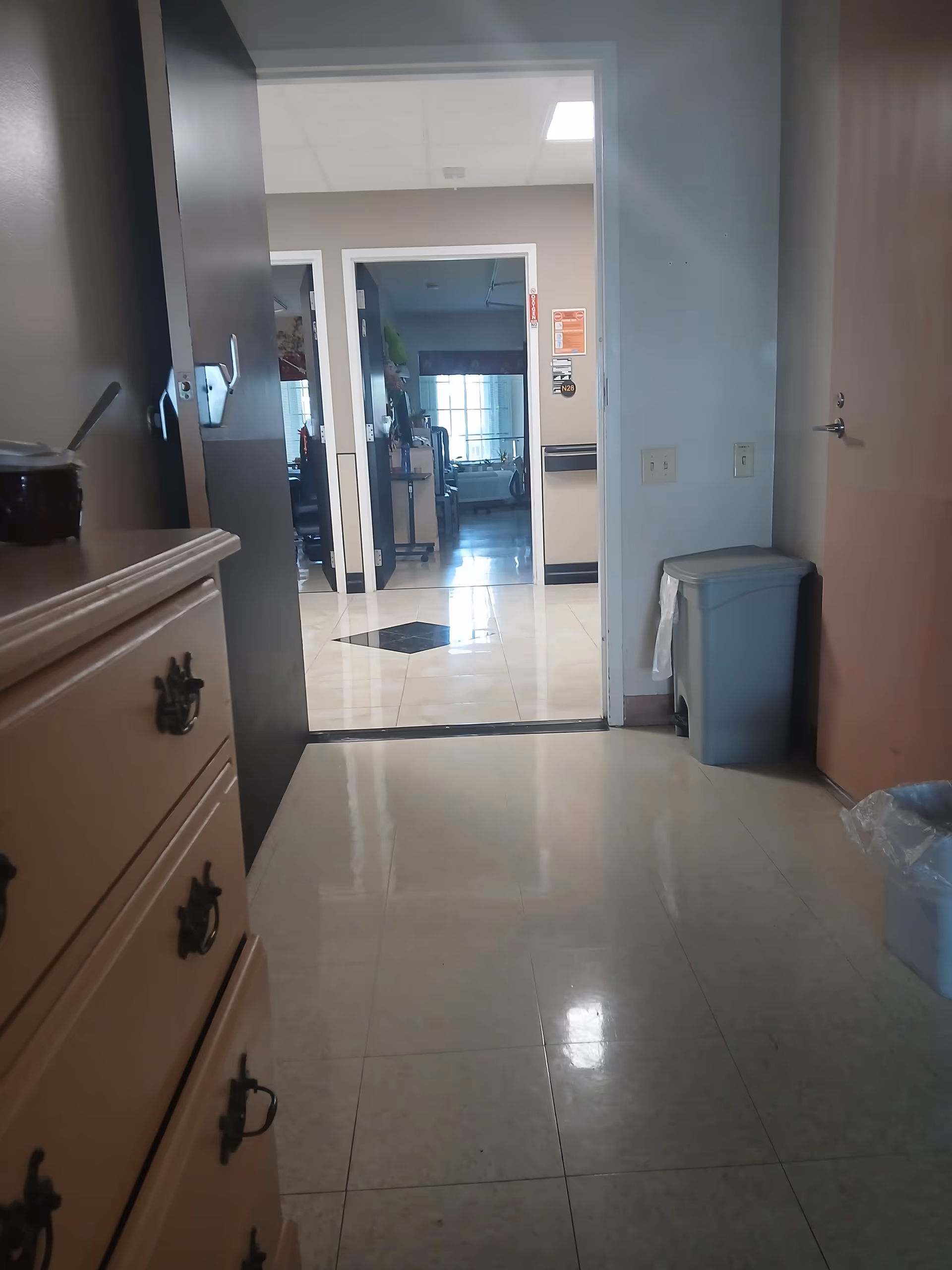 Hospital-like corridor inside Coral Reef Subacute Care Center with open doors.