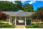 Front view of a single-story facility entrance with a porch and well-kept lawn.