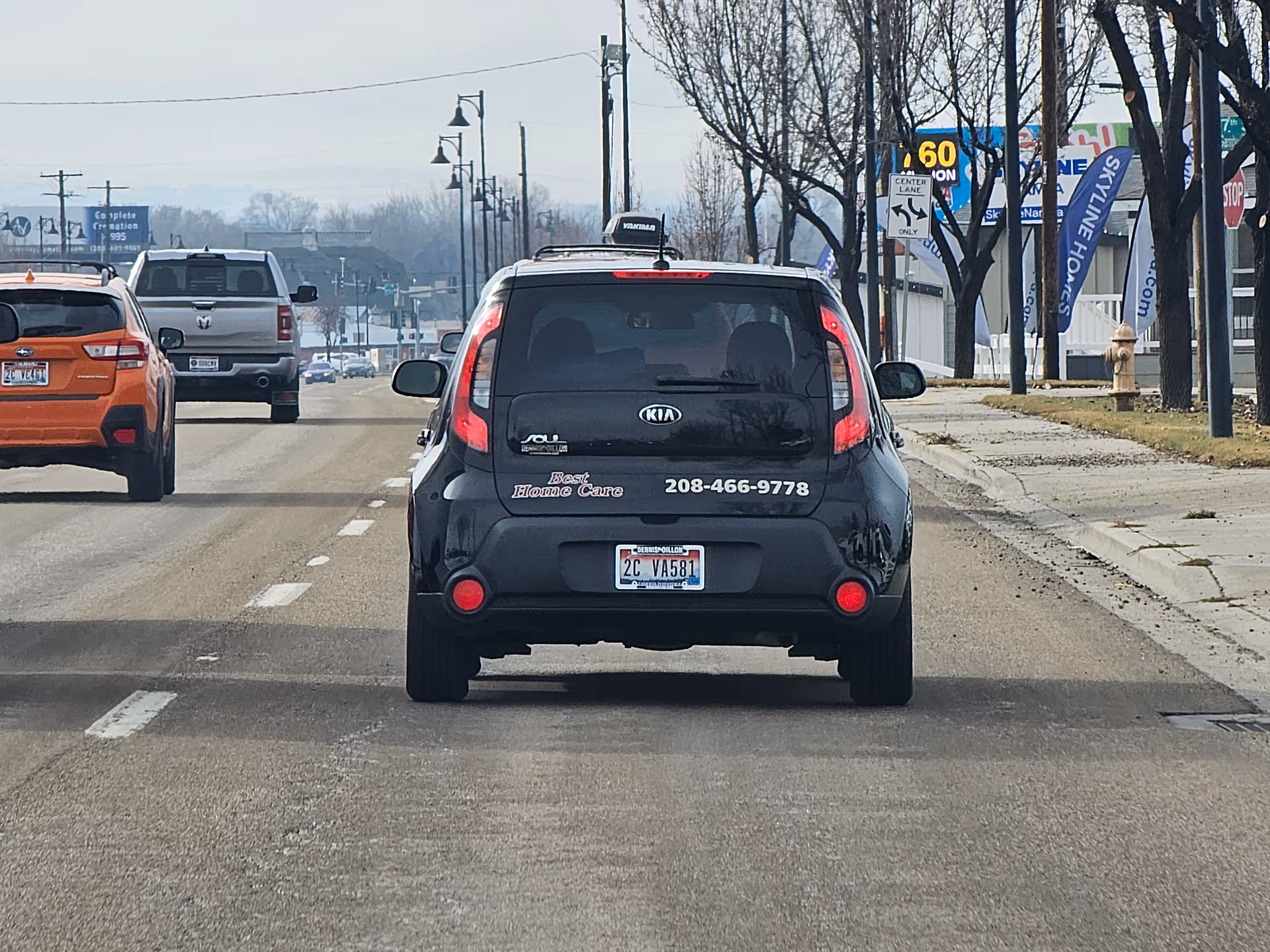 Rear view of a black Kia Soul van with Best Homecare and Staffing signage.