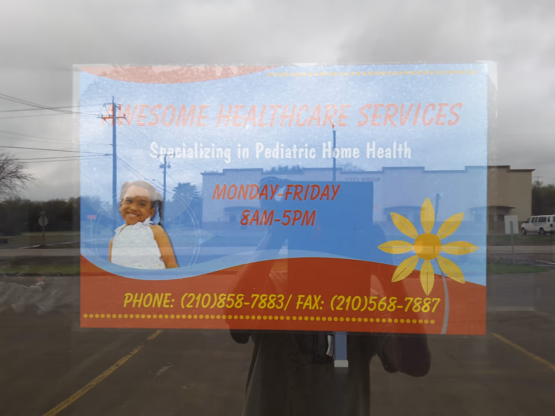 Reflective storefront window sign advertising Awesome Healthcare Services with hours and flowers.