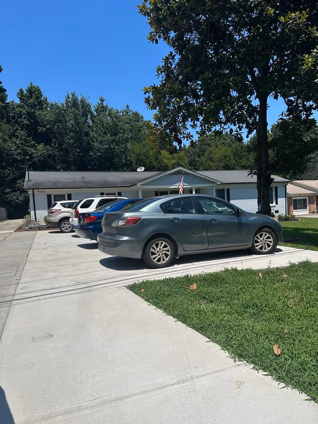 Front exterior view of Blissful Living Senior Care with parked cars.