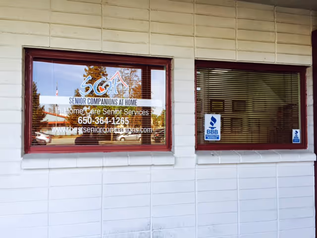 Exterior view of a building with Senior Companions At Home signage in windows.