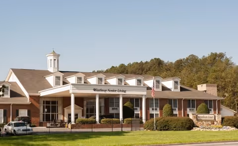 Exterior view of Winthrop Court senior living facility with entrance and manicured lawn.