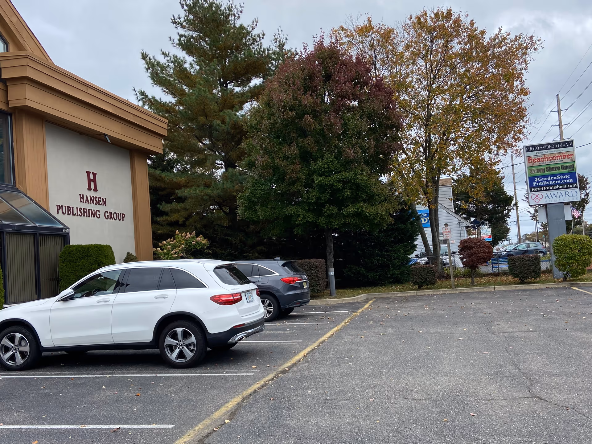 Exterior view of a building with Hansen Publishing Group sign and parking lot.