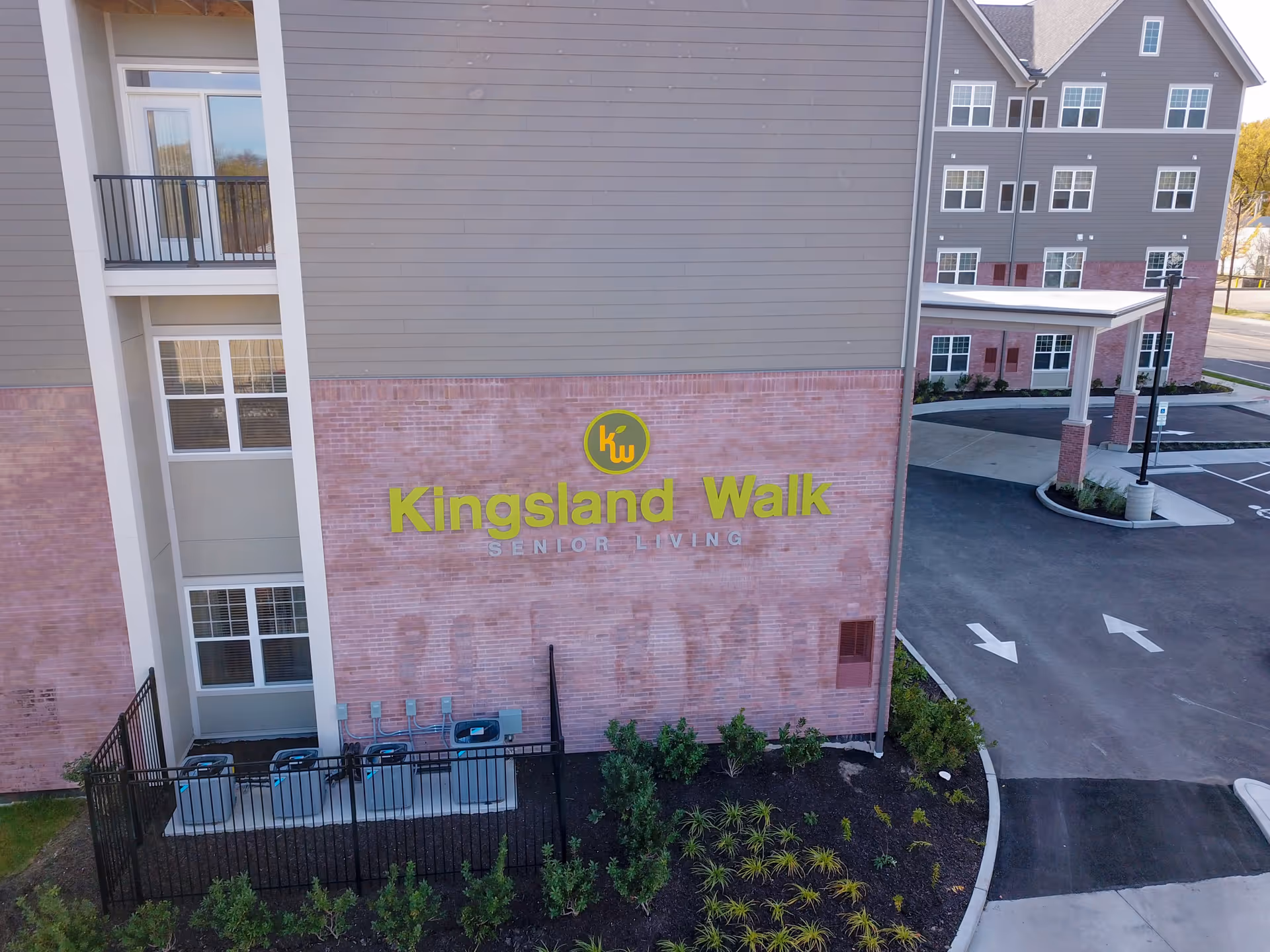 Exterior view of the Kingsland Walk Senior Living facility with signage.