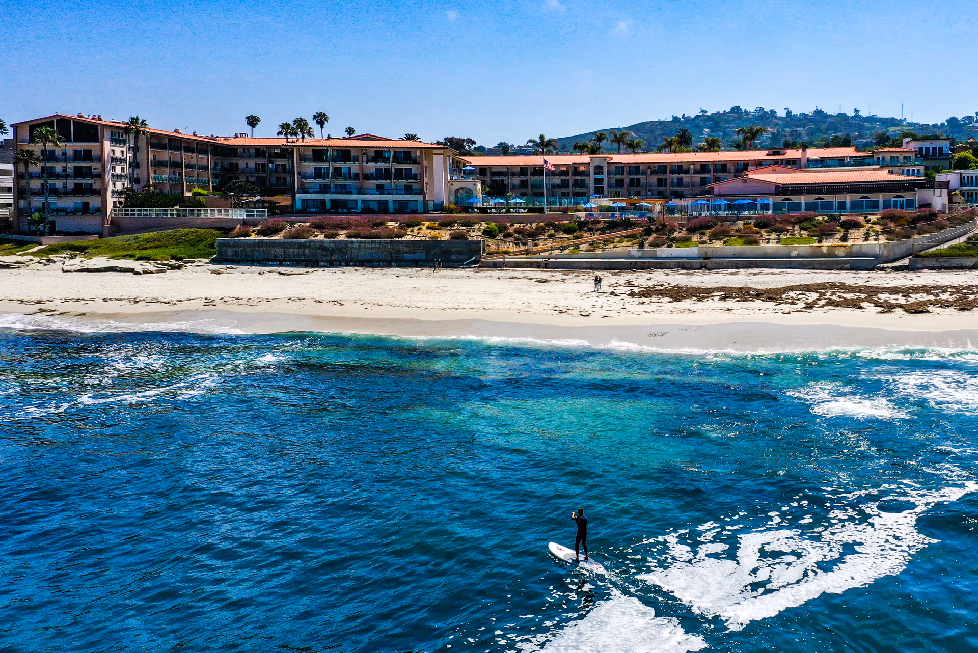 Exterior view of White Sands La Jolla, oceanfront campus with red-roofed buildings.