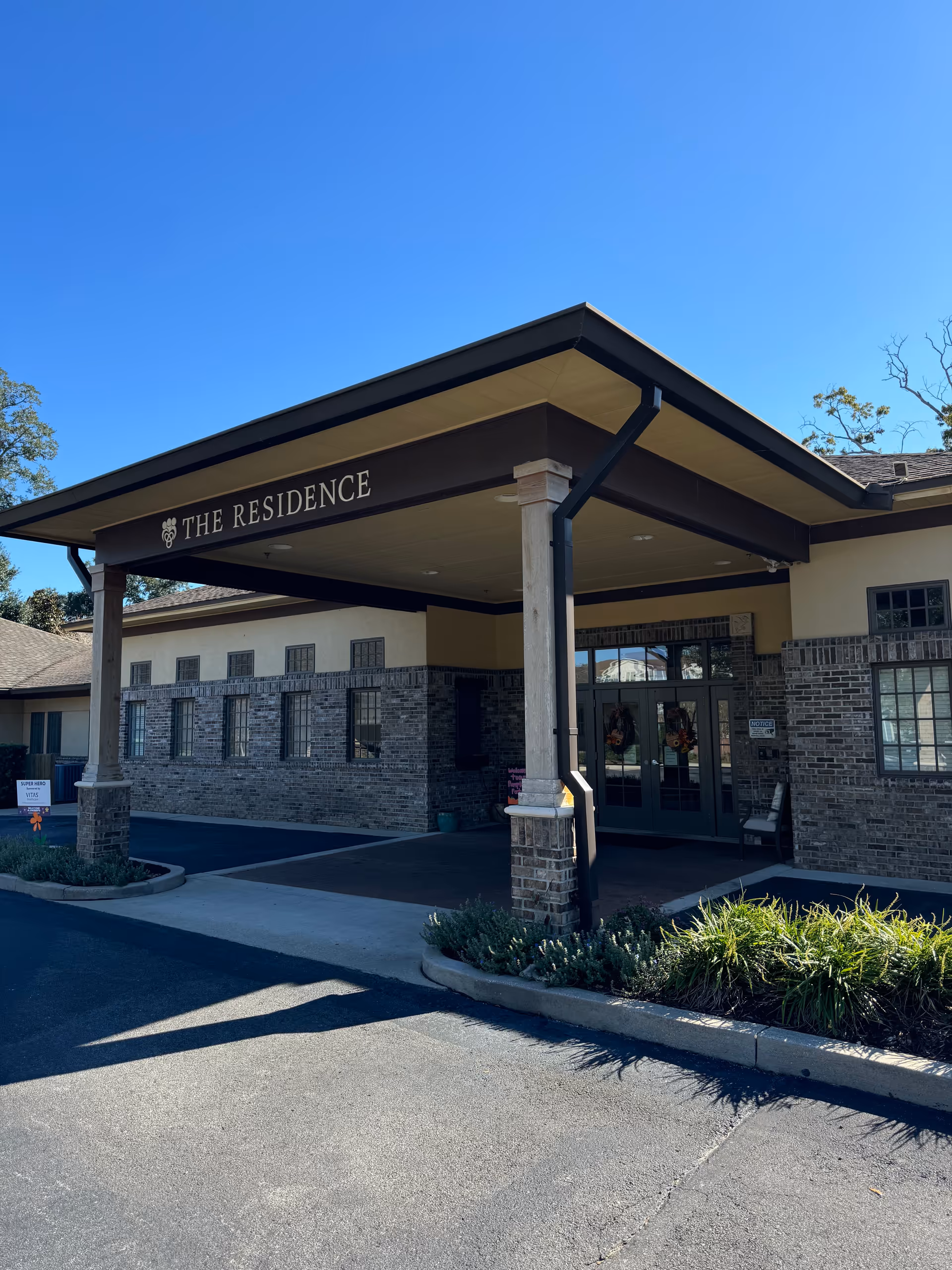 Front exterior of The Residence, a VITAS Healthcare facility entrance under a covered canopy.