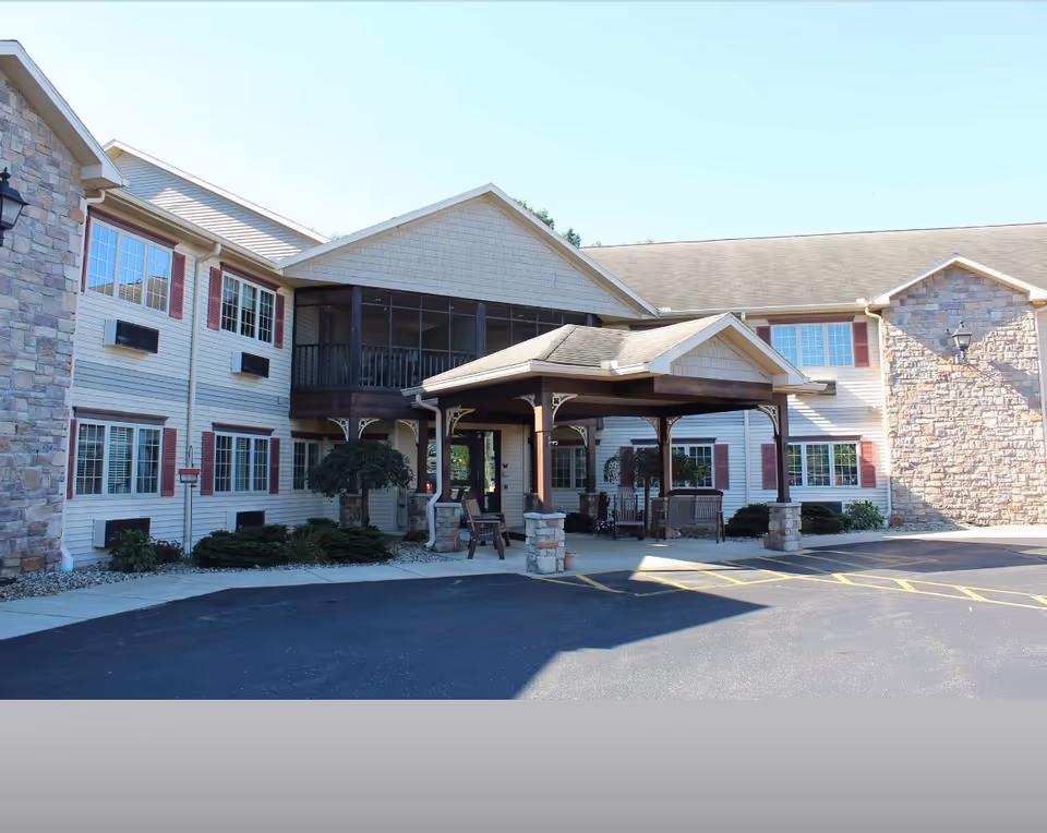 Exterior view of Miller's Senior Living Community with entry canopy and parking.
