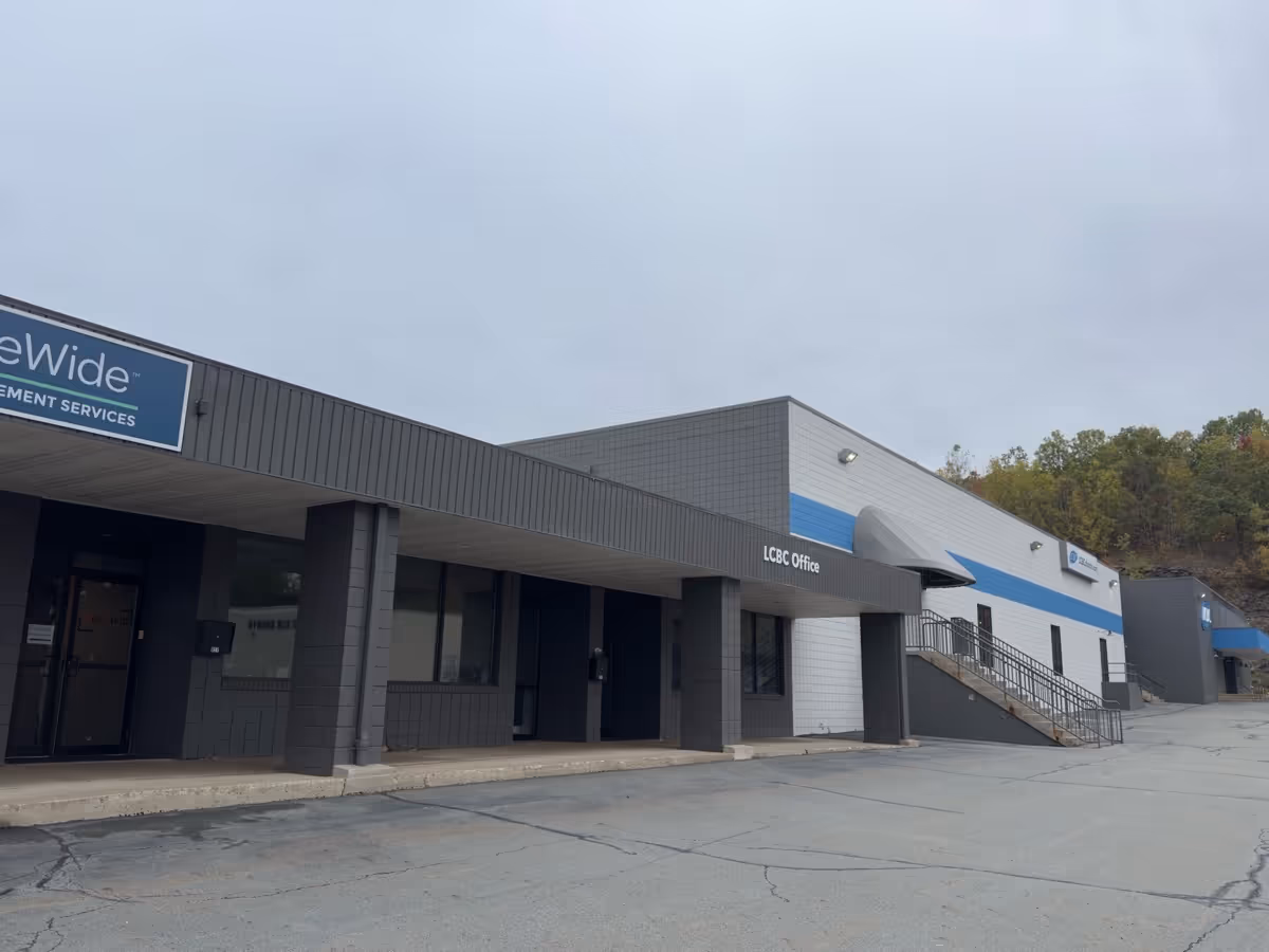 Exterior view of a commercial building with HireLivin Homecare signage and blue accent stripe.