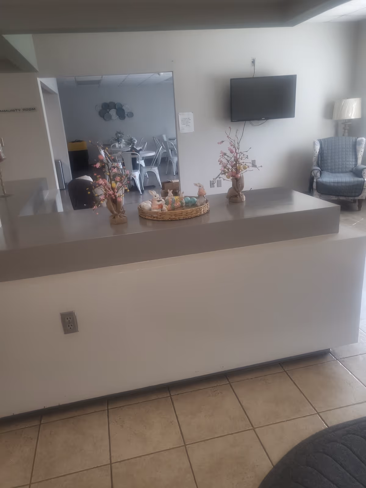 Bright lobby reception area with desk, decor, and seating.