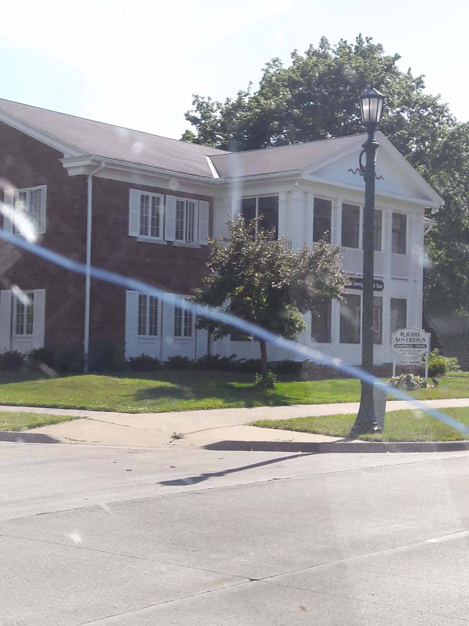 Exterior view of Rachel Sovereign Memorial Home with brick facade and white columns.