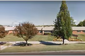 Front exterior view of Morningstar Residential Care Center, with trees and a lawn.