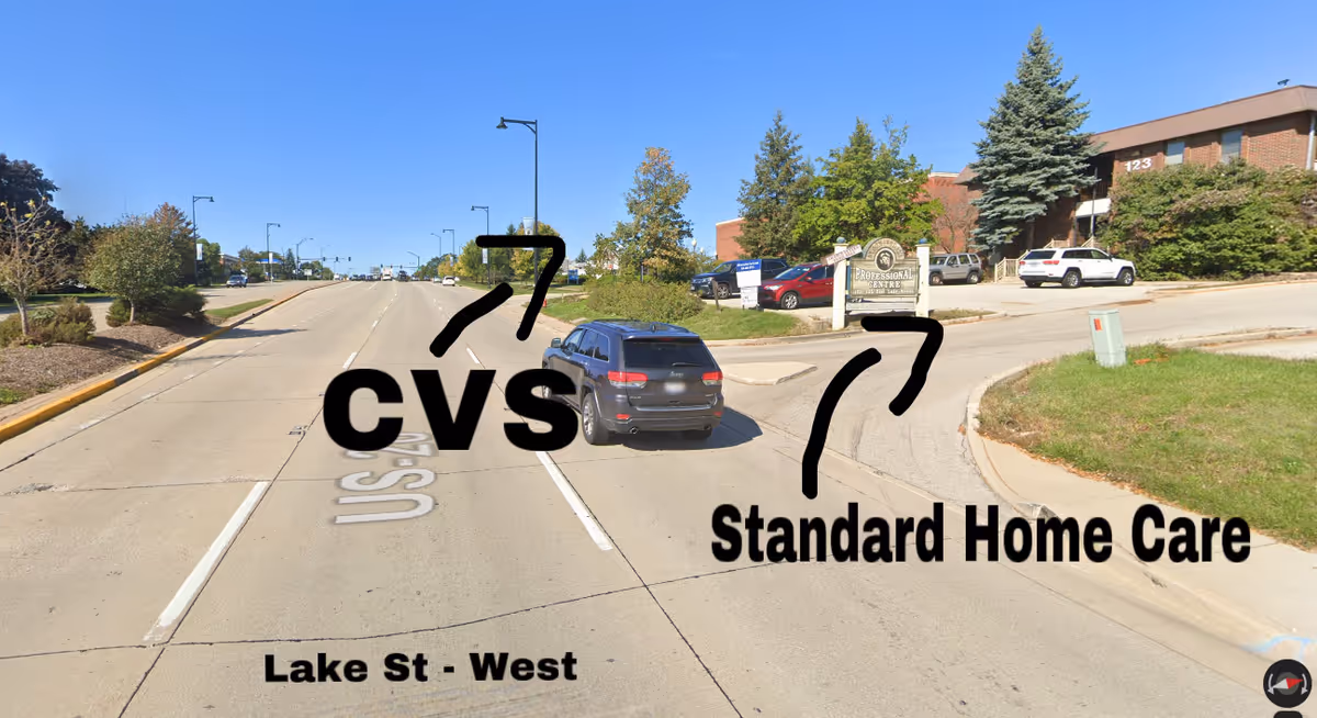 Wide street view with CVS branding and Standard Home Care signage visible.