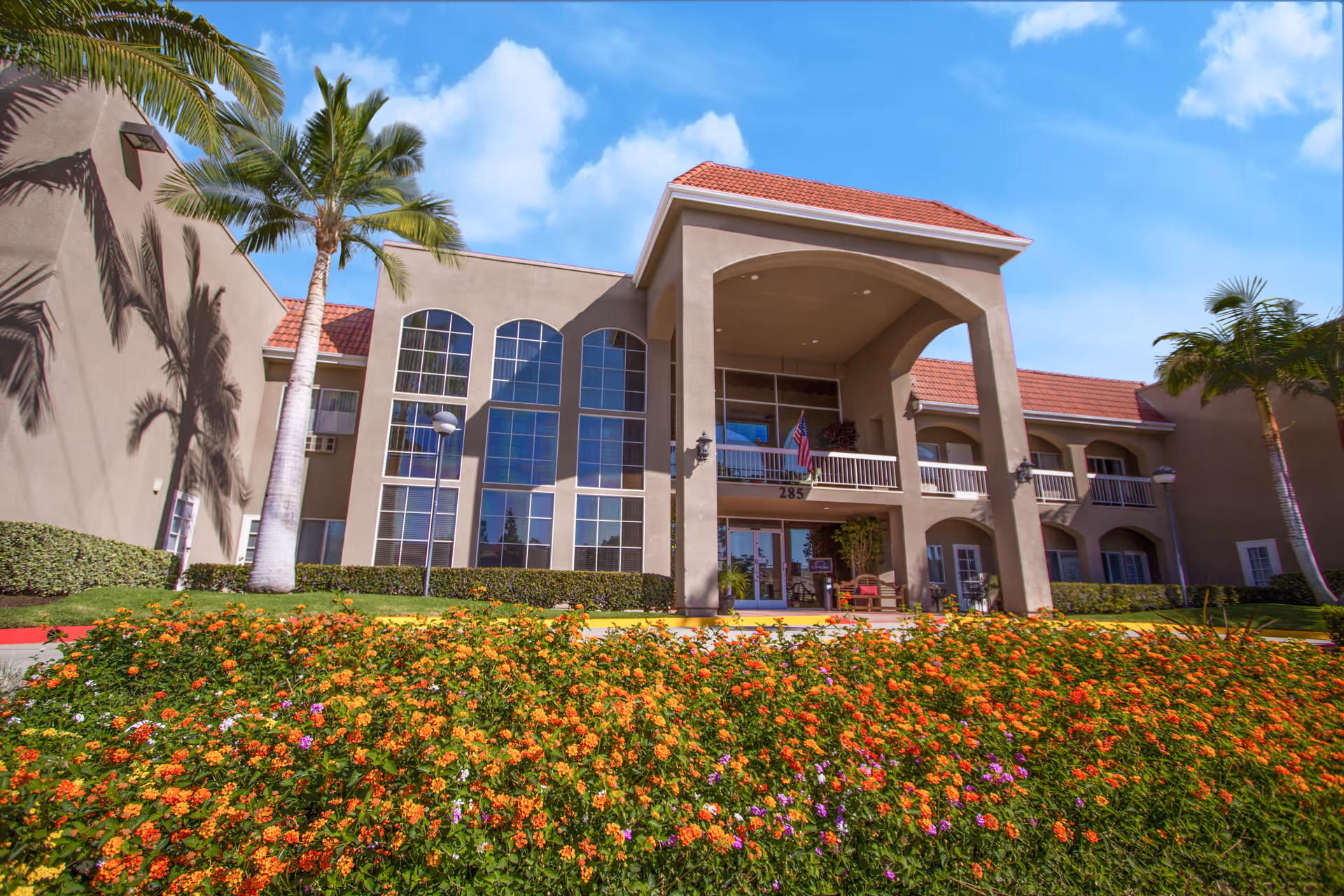 Exterior view of Brookdale Brea with arched entrance and landscaping.