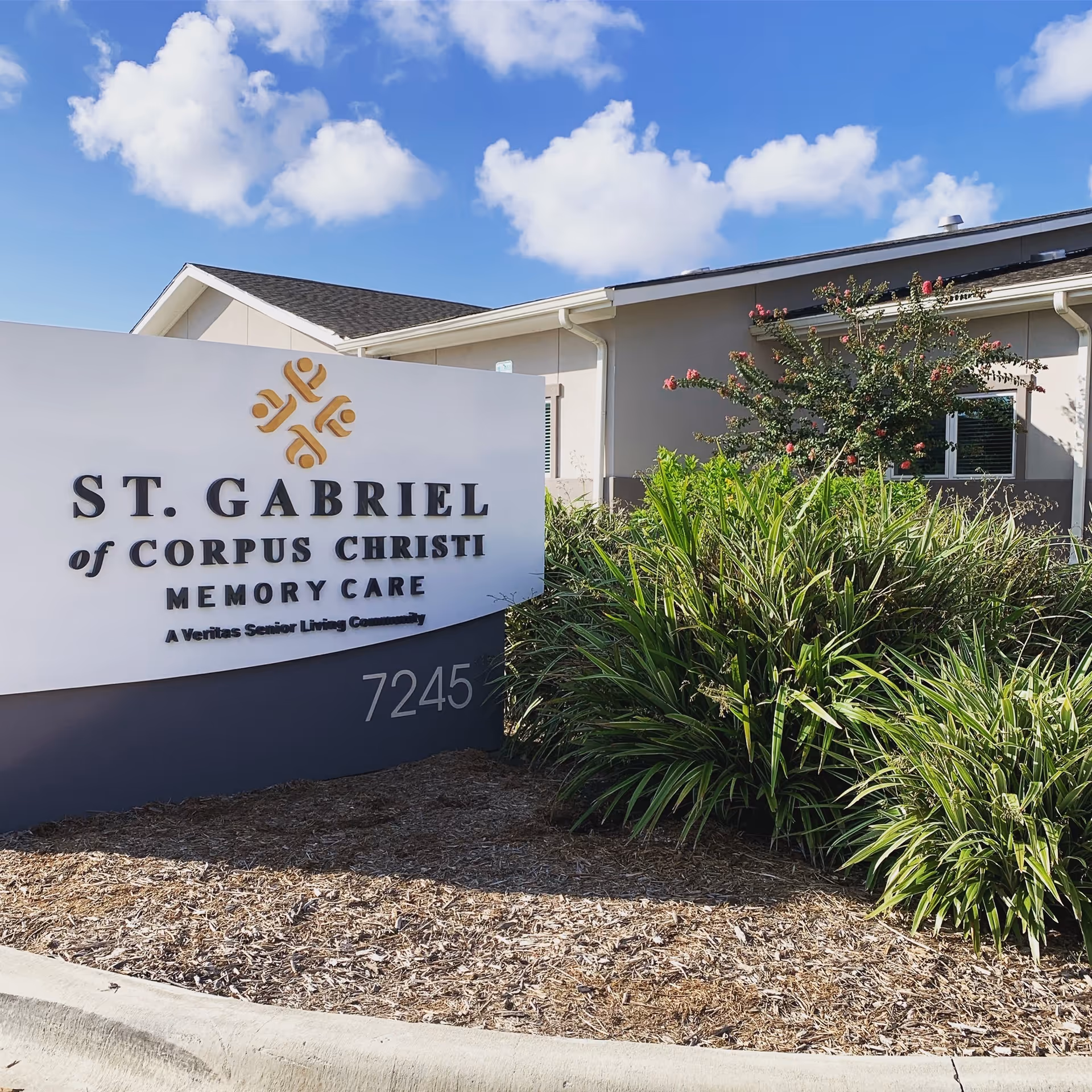Exterior view of St. Gabriel of Corpus Christi Memory Care sign with landscaping.