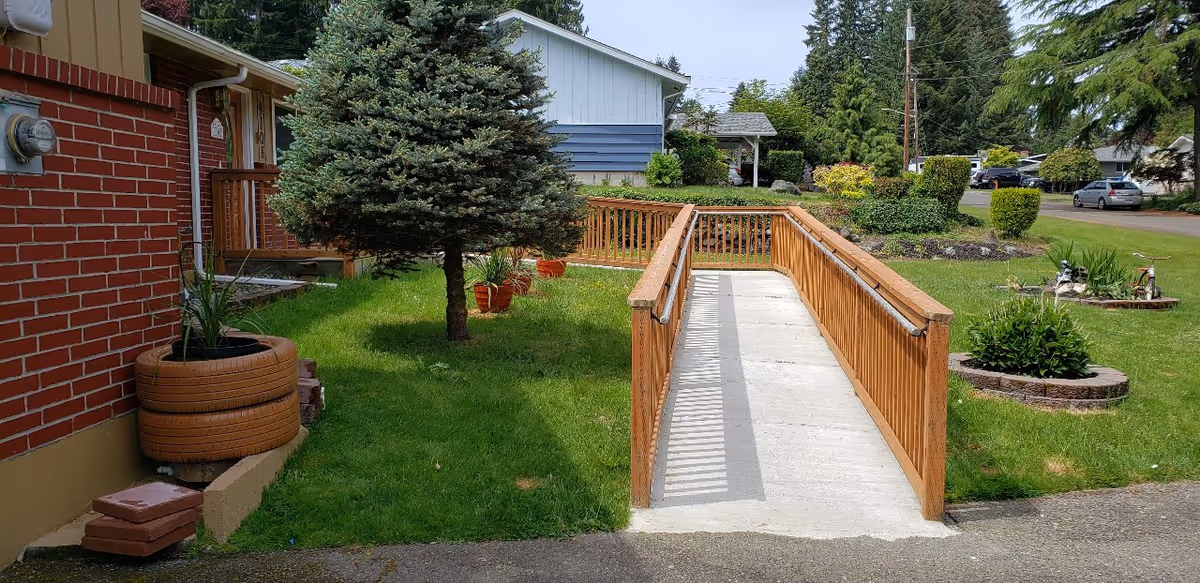 Exterior view of Annie's Pointe Adult Family Home with a ramp and green yard.
