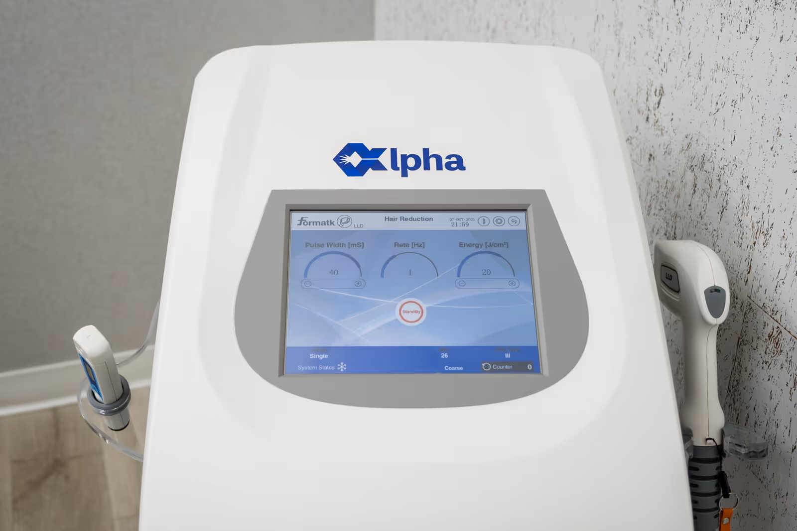 White Alpha medical device with touchscreen sits in a clinical interior.