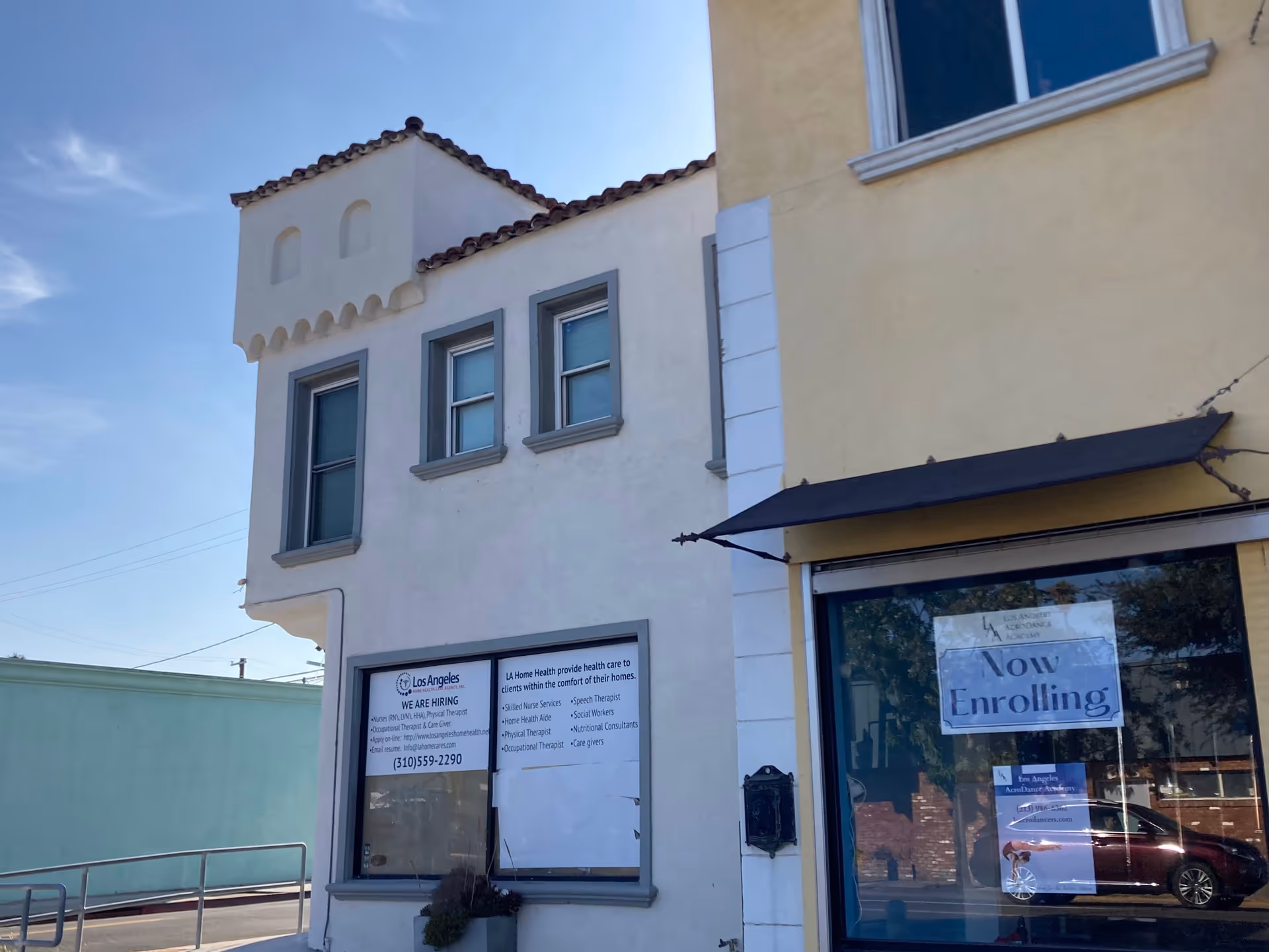 Exterior of Los Angeles Home Health Care Agency building with enrollment sign in the storefront window.