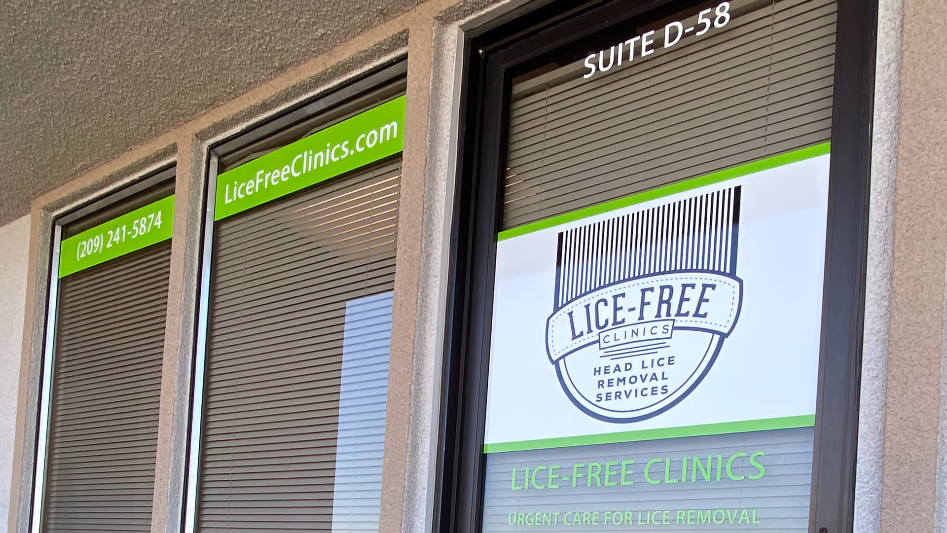 Exterior of a building with Lice-Free Clinics signage and green banners.