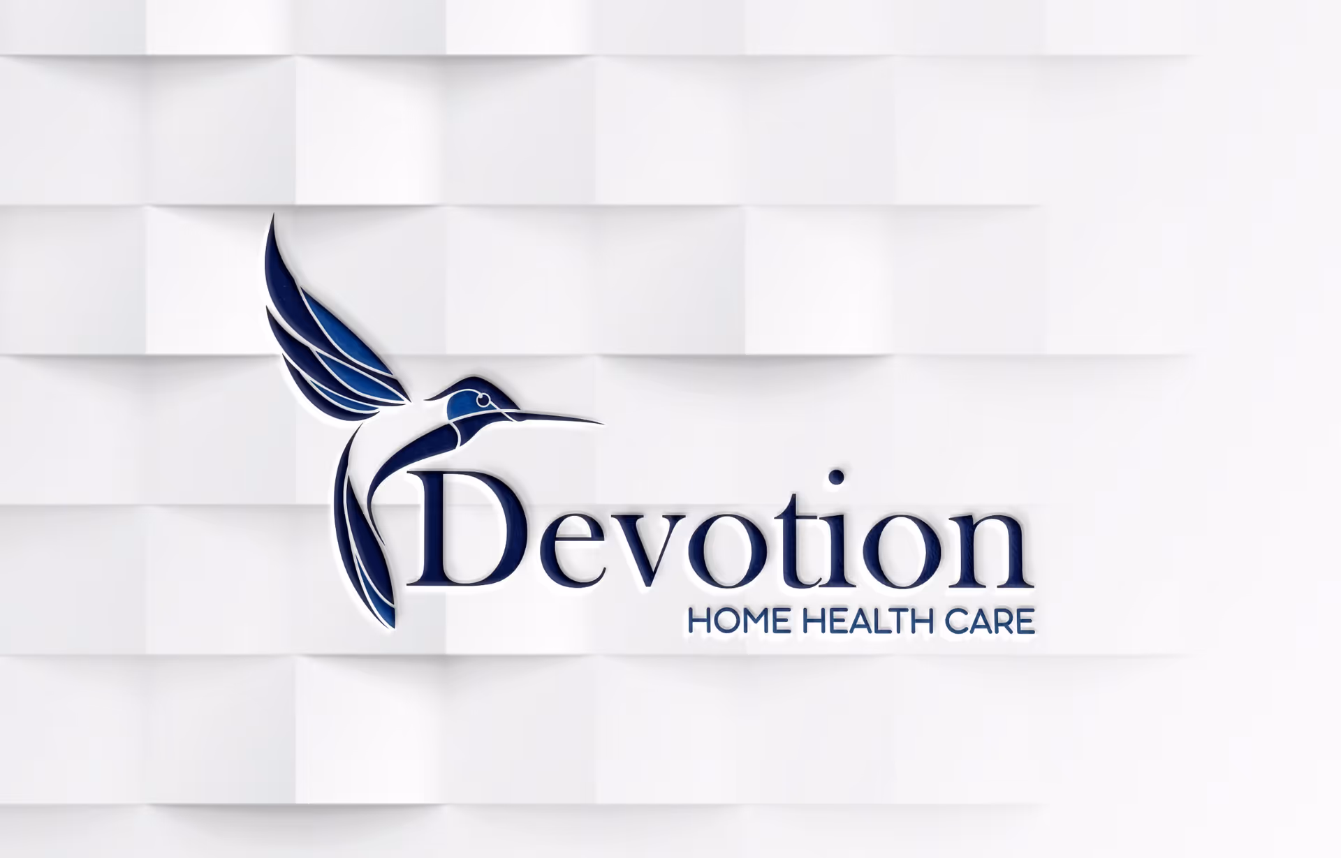 Devotion Home Health Care sign with blue hummingbird on a white tile wall.