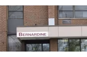 Bernardine sign above a brick building entrance.