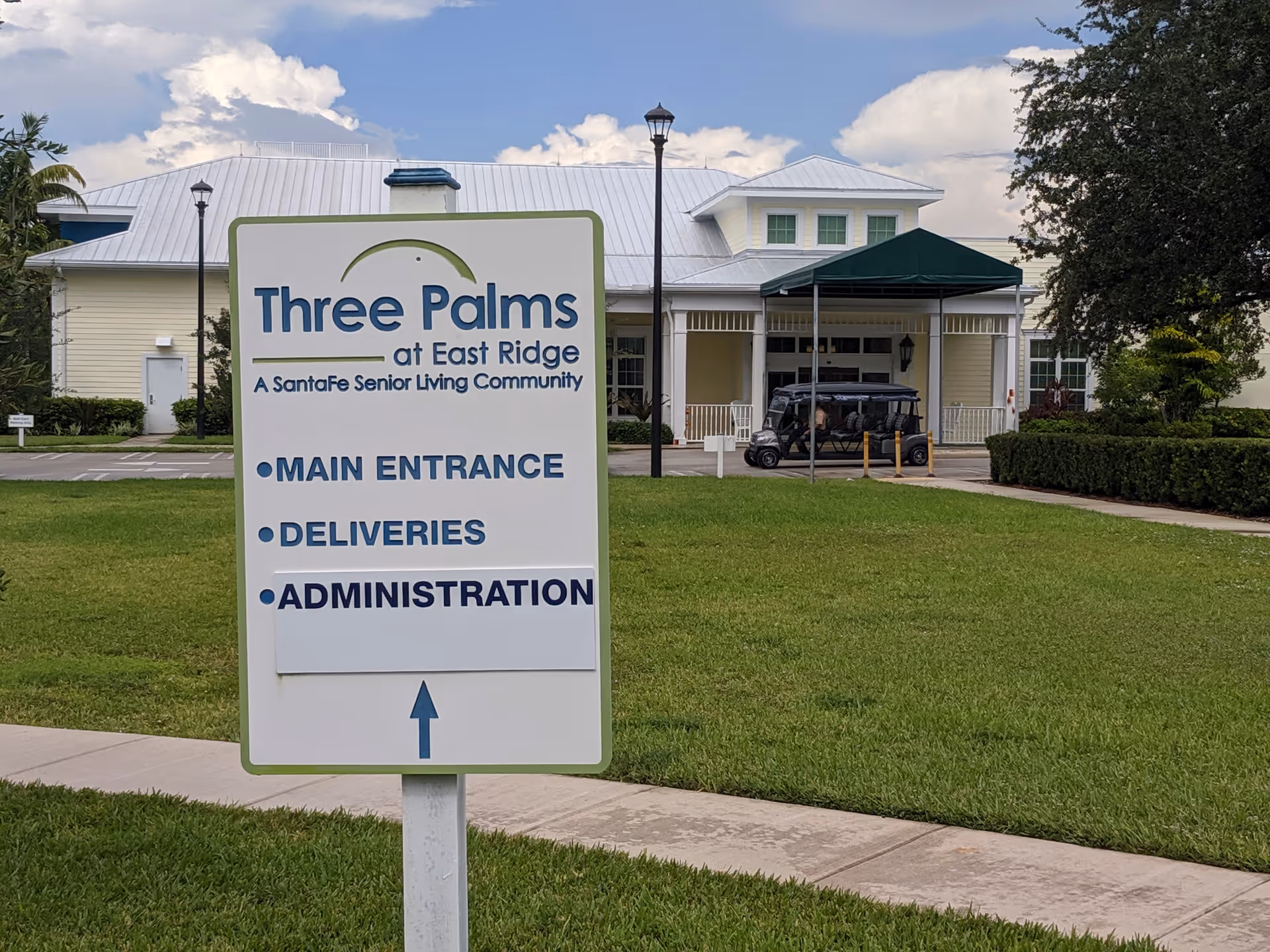 Wide shot of East Ridge at Cutler Bay exterior with a large sign in front
