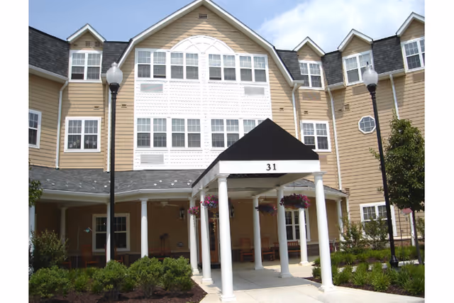 Exterior view of AVIVA Baldwin Park building entrance with white columns and a covered porch.