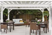 Outdoor patio with wicker tables and chairs under a white pergola at Linden Grove.