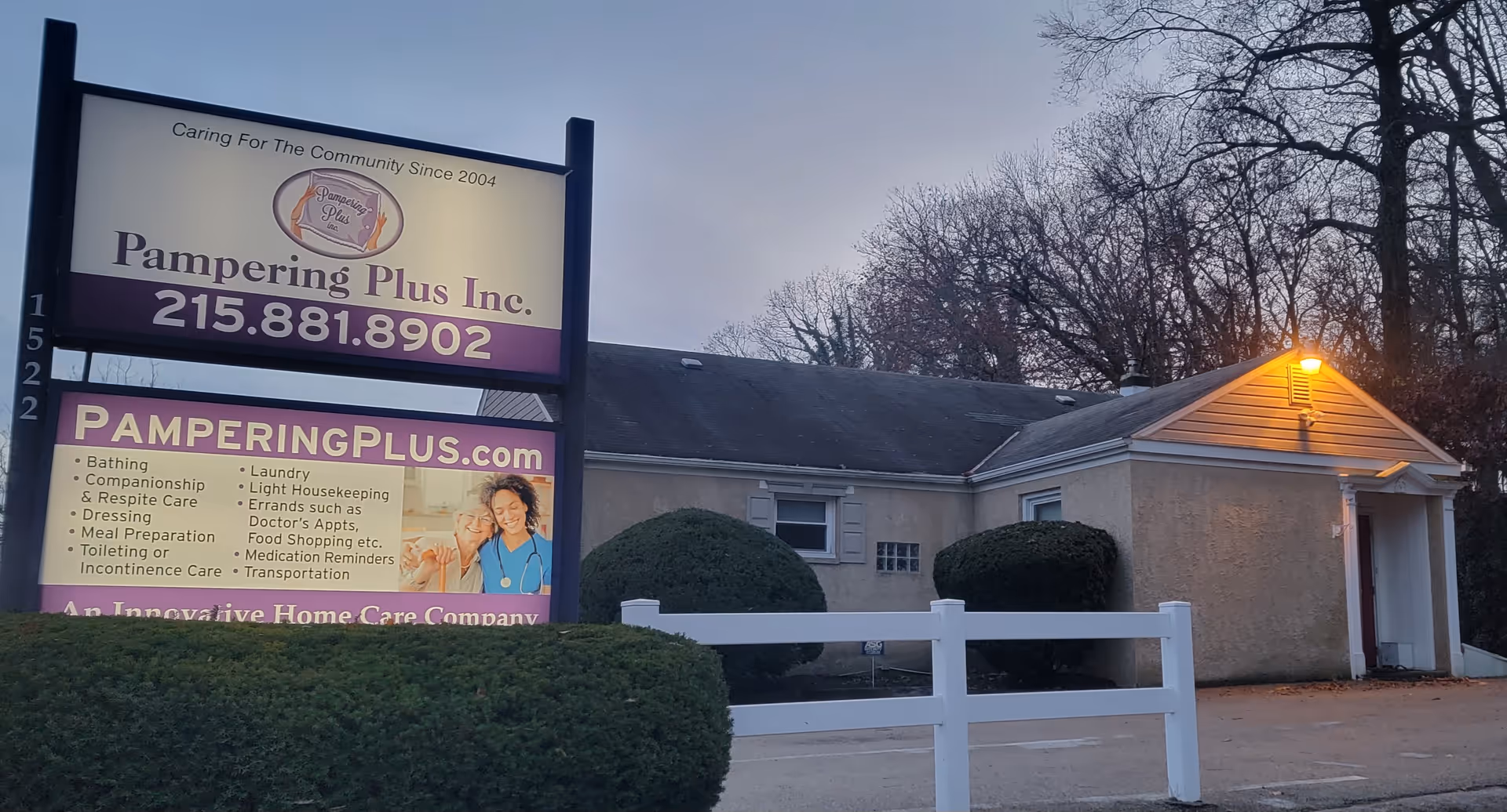 Exterior view of Pampering Plus facility with large signboard and low, single-story building.