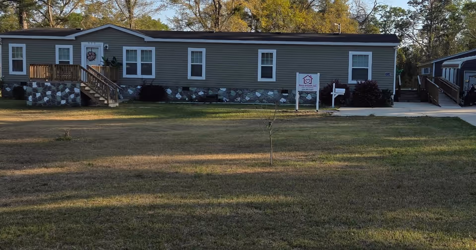 Exterior view of Peace on Earth LLC care facility with front porch and sign