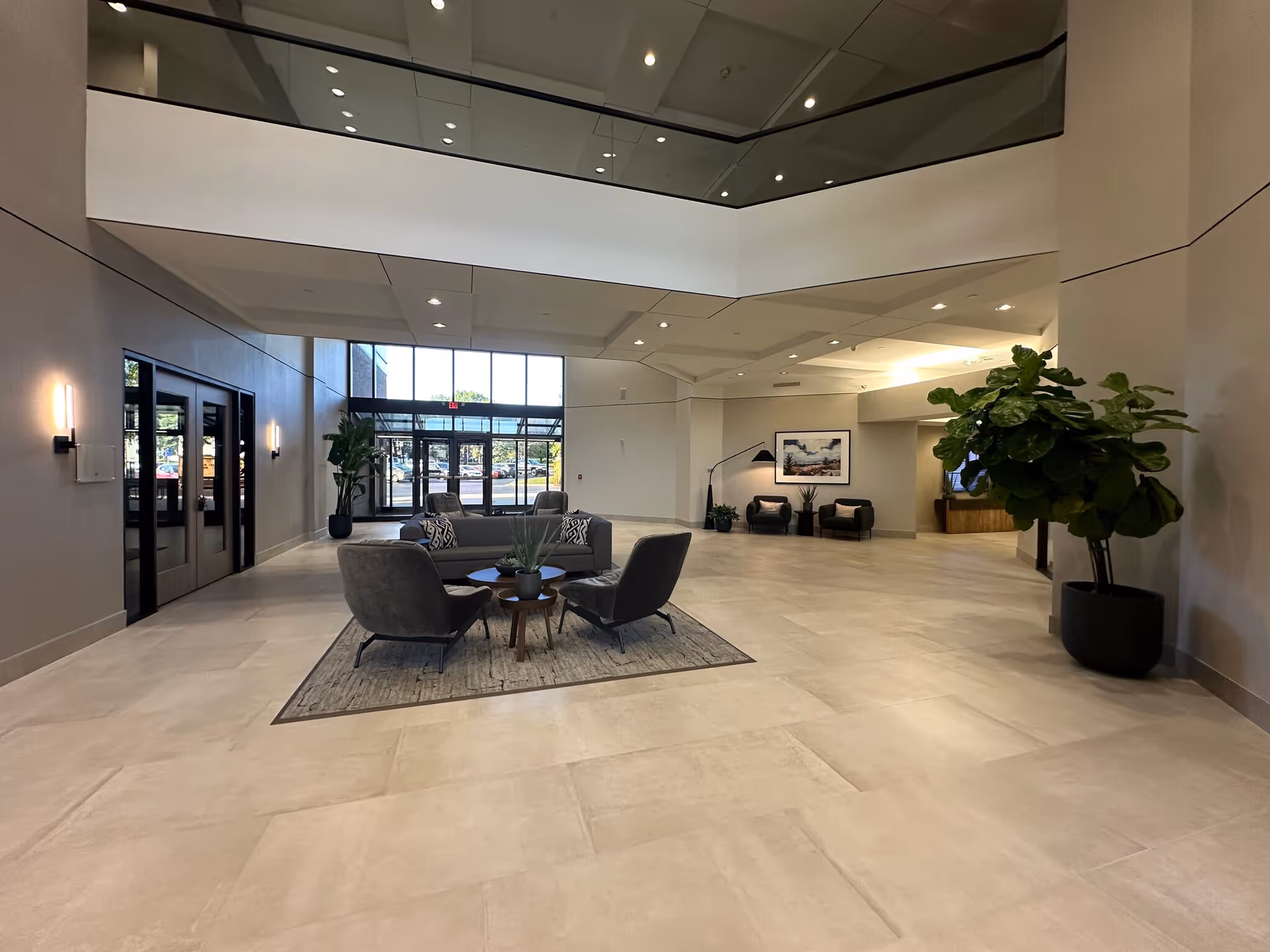 Modern Alpine Care Home Health lobby with seating, plants, and large glass doors.