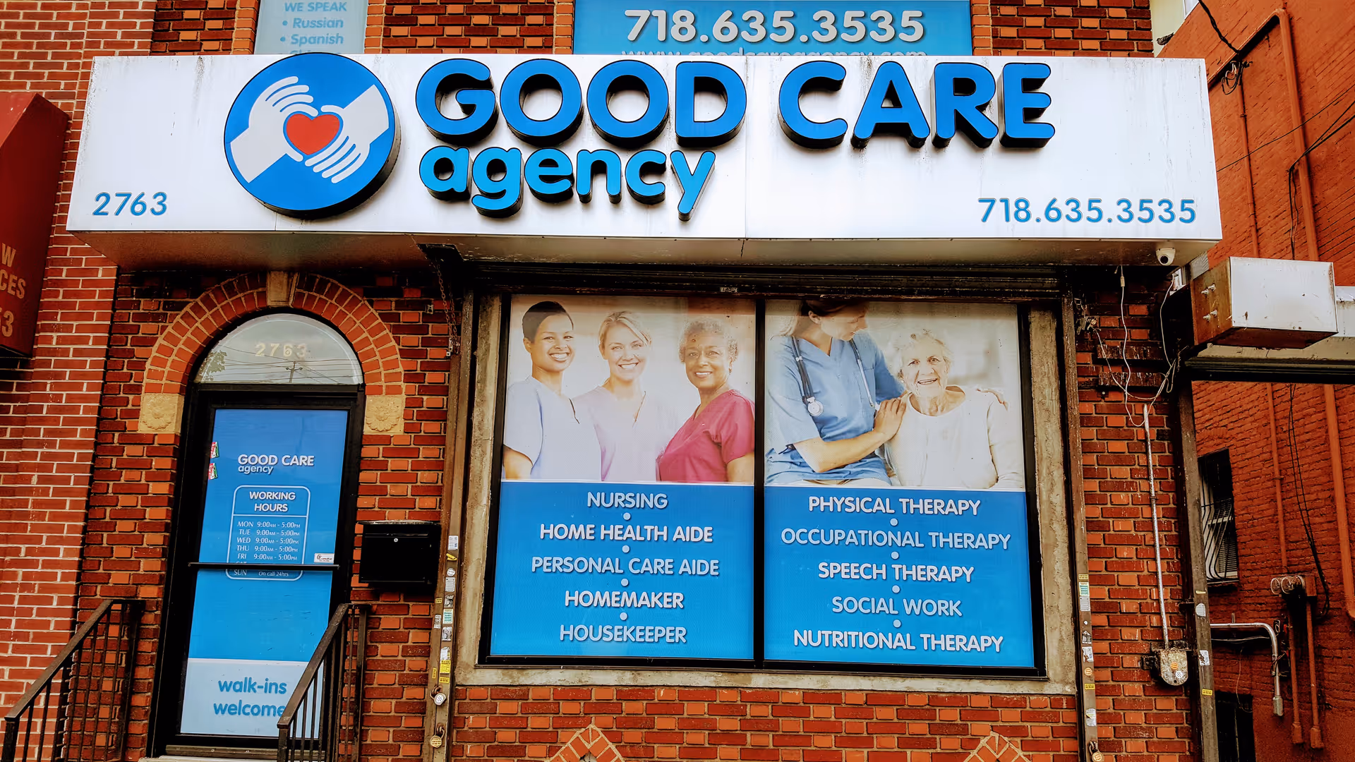 Brick storefront with a Good Care Agency sign and posters advertising services.