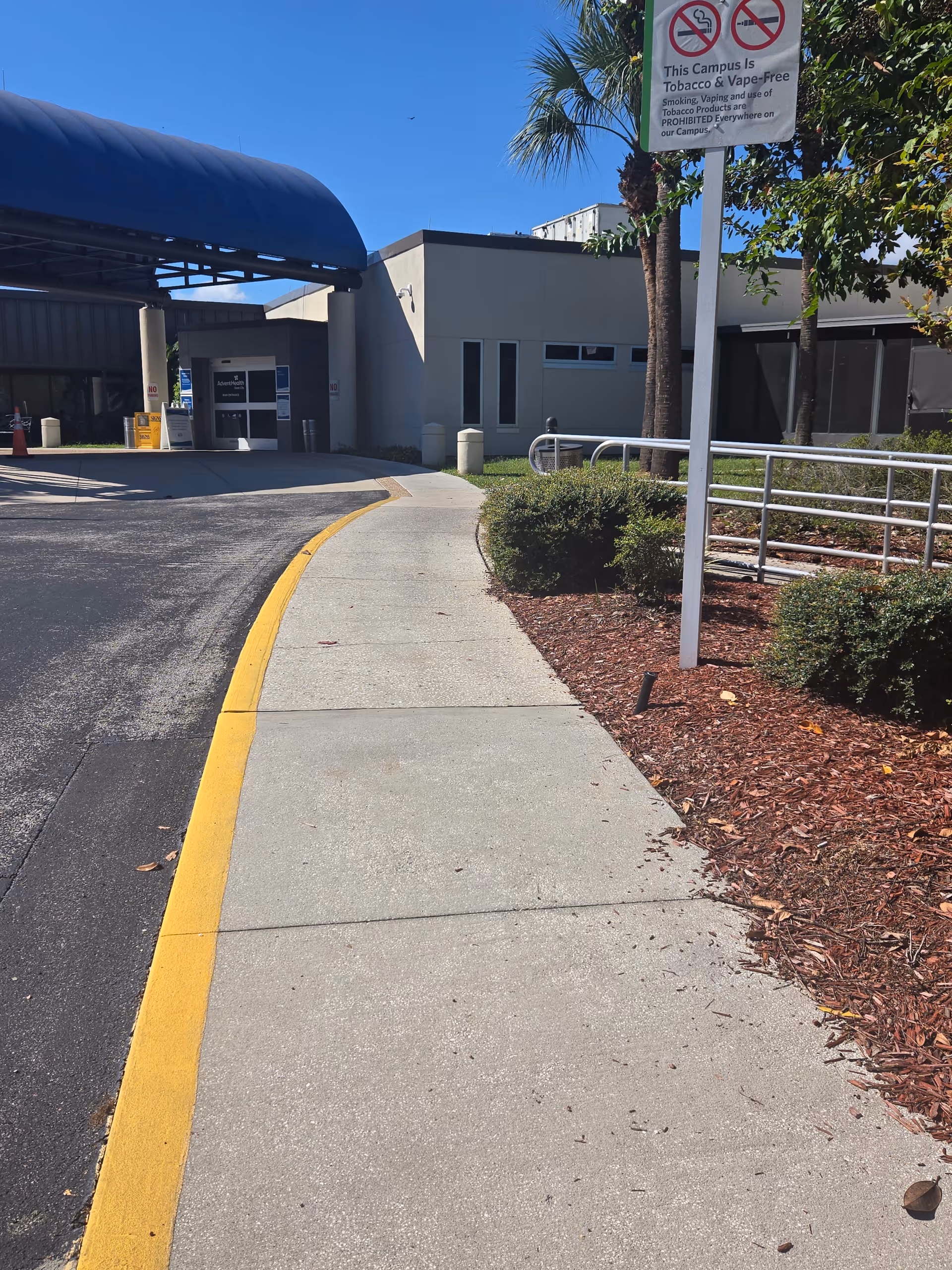 Exterior view of AdventHealth Dade City with curved blue canopy over entrance and walkway