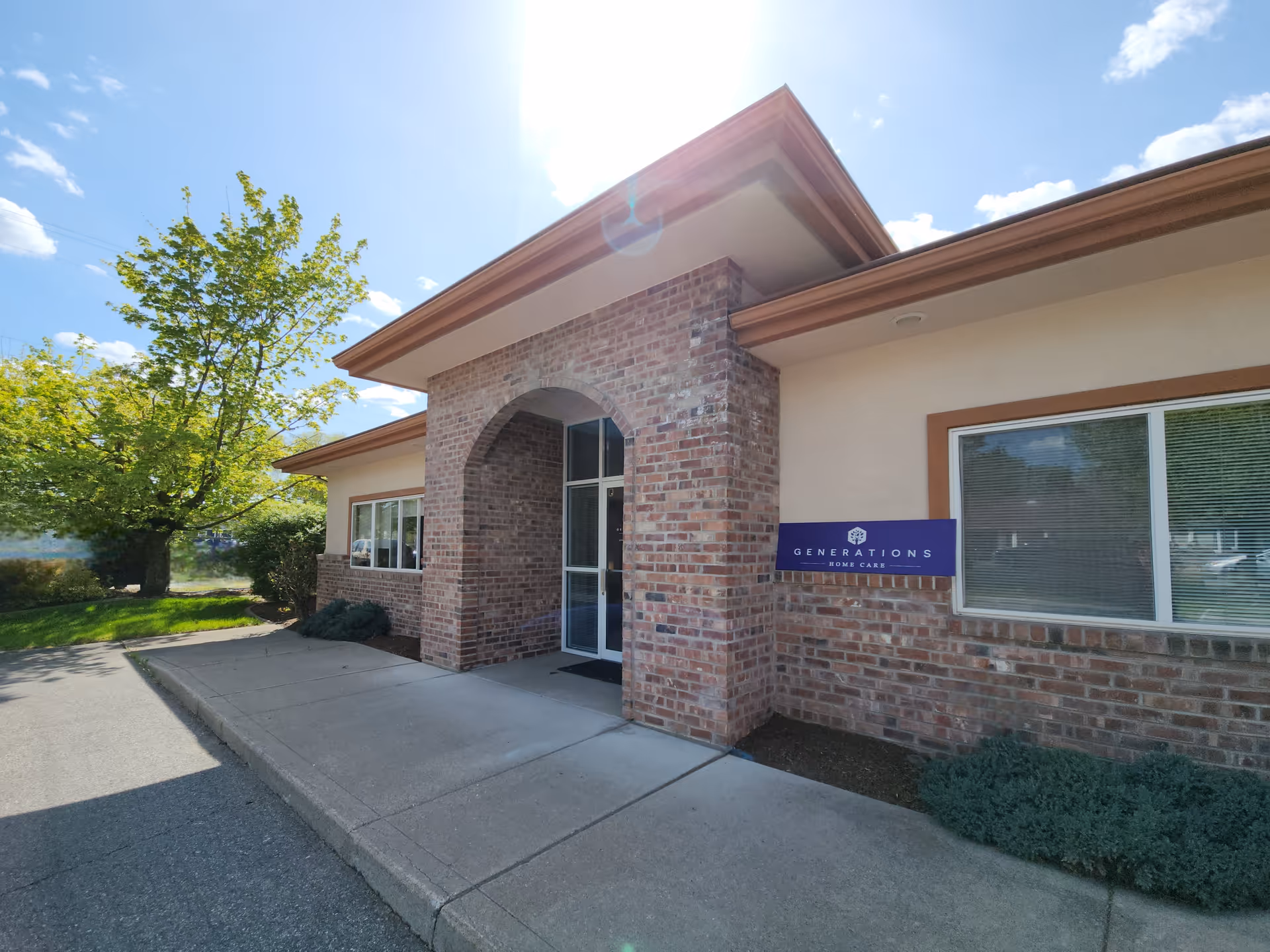 Brick building exterior with arched entrance and Generations Home Care sign.