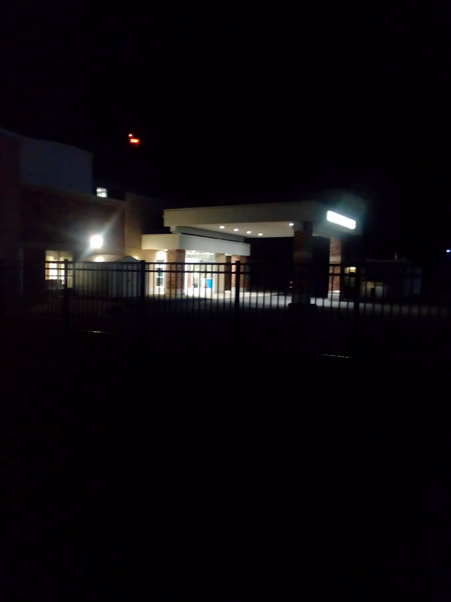 Nighttime exterior of RRH Newark-Wayne Community Hospital entrance with a lit canopy.