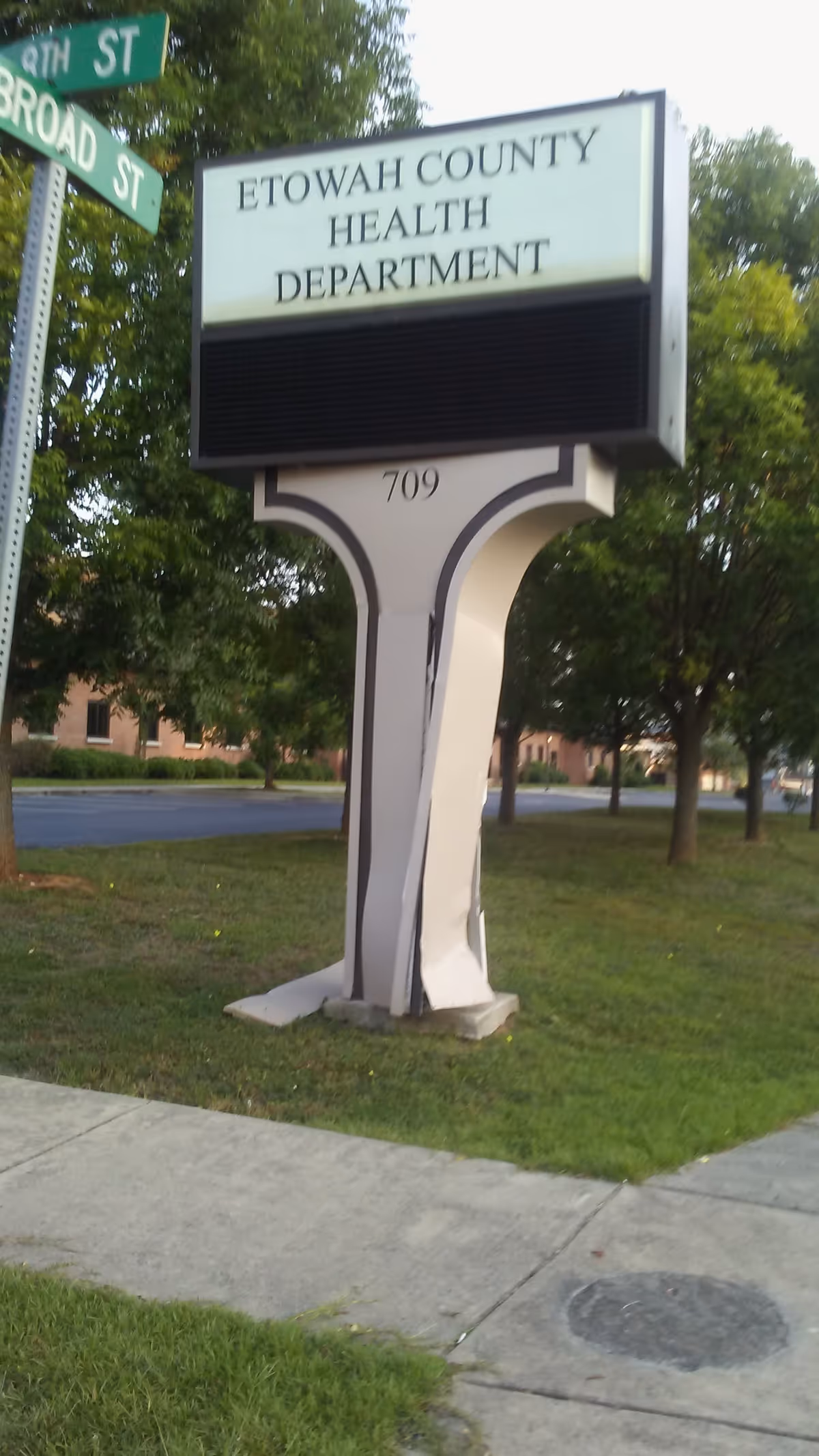 Tall sign reads Etowah County Health Department outside with trees in the background.