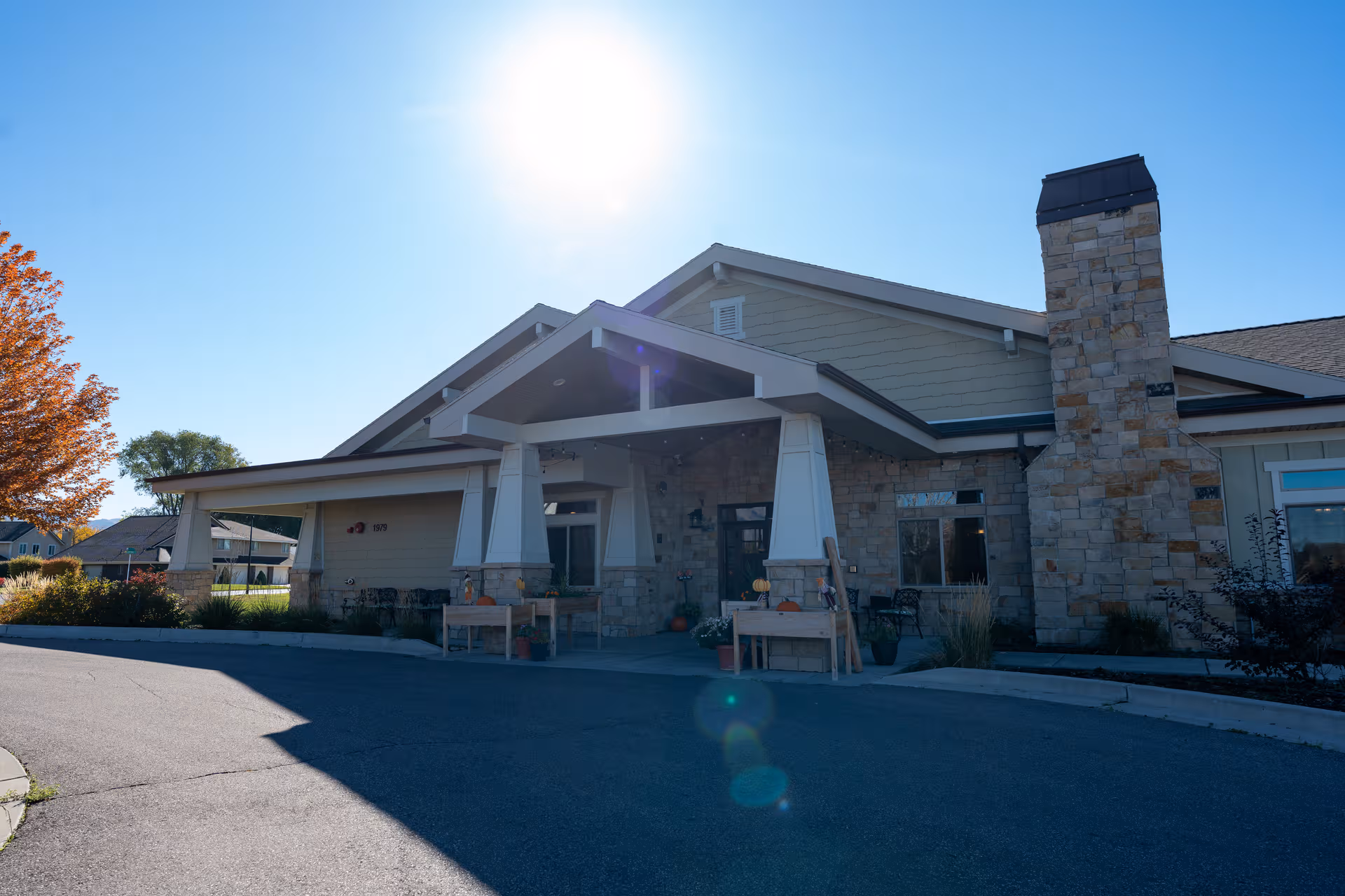Front view of Seasons Assisted Living building with stone facade and a covered entrance.