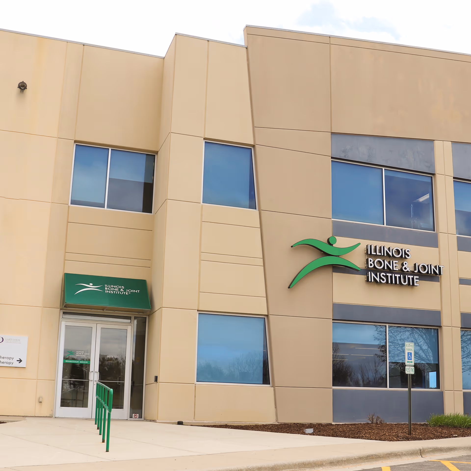Exterior view of a beige medical facility building front with Illinois Bone and Joint Institute sign.