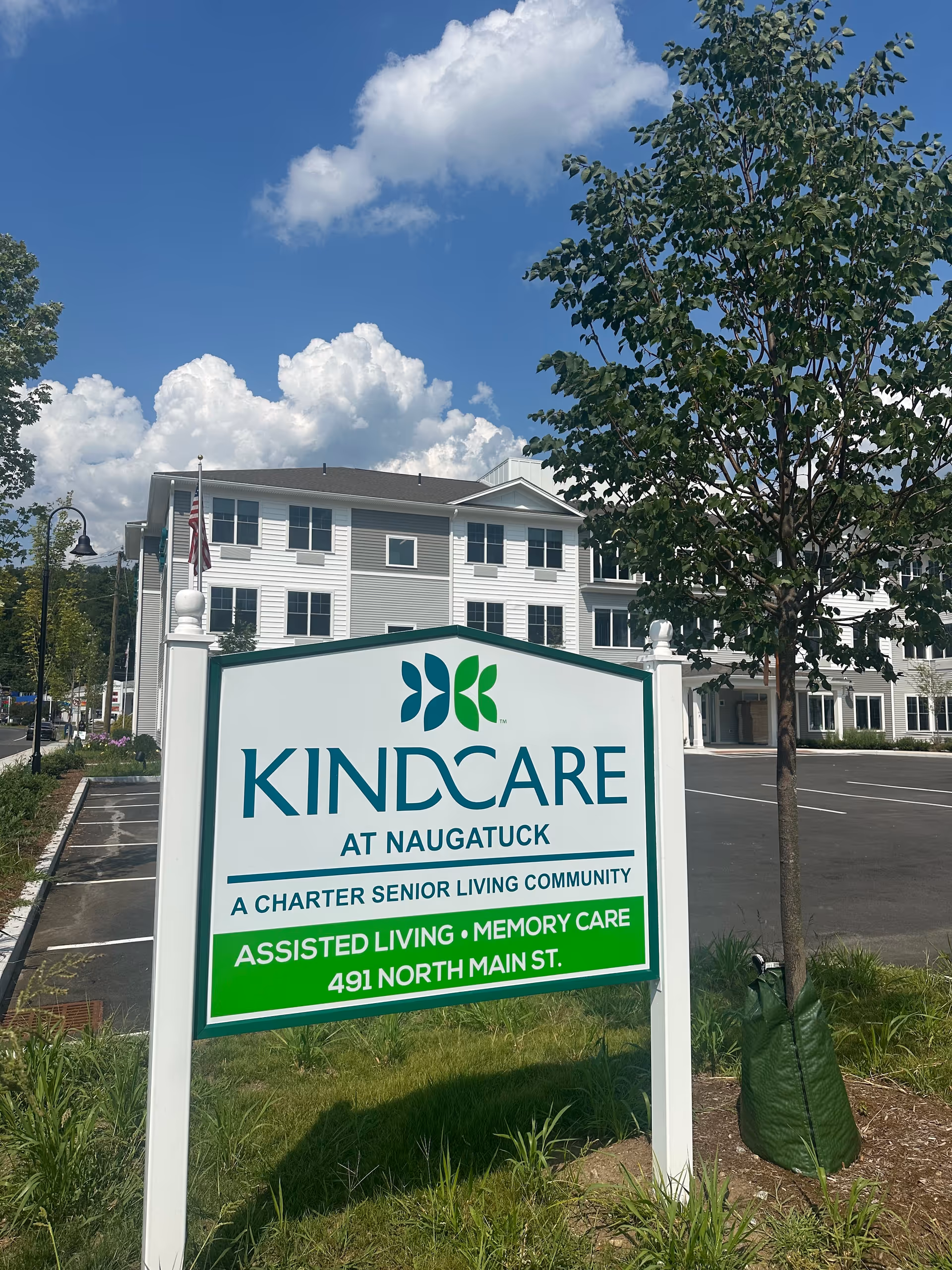 Front exterior of KindCare at Naugatuck with sign and building behind.