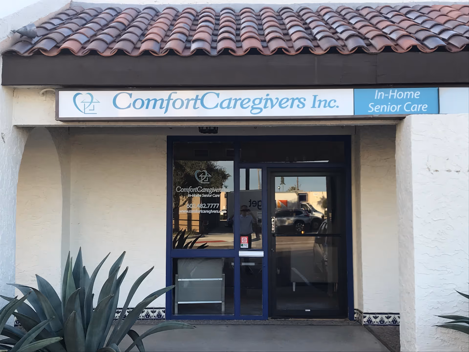 Exterior view of Comfort Caregivers storefront with sign reading In-Home Senior Care.