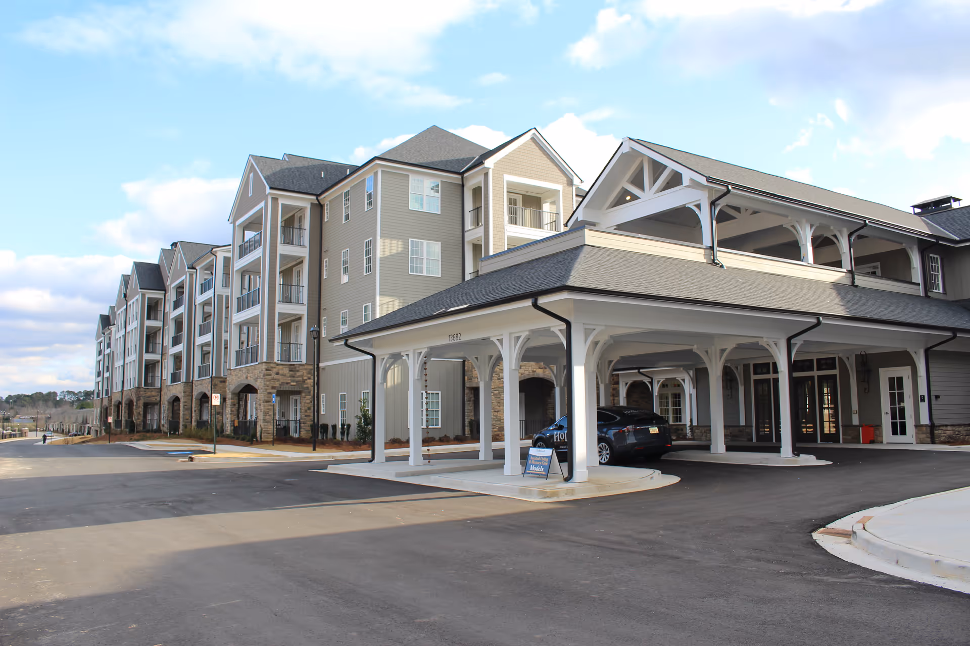 Holbrook Woodstock senior living facility exterior with a covered entrance and multi-story building